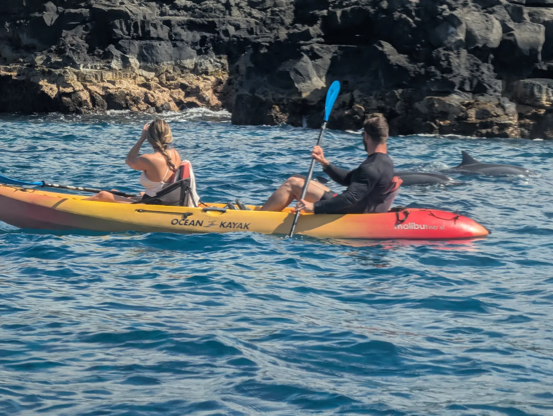 Guests kayaking along Kona’s lava coastline